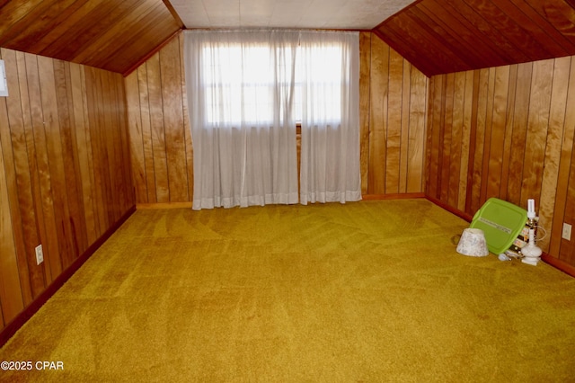 bonus room with lofted ceiling, wooden walls, and carpet