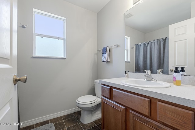 bathroom featuring toilet, vanity, and a shower with curtain