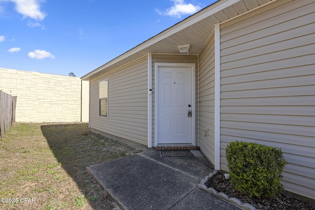 property entrance with a yard