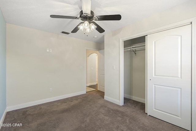 unfurnished bedroom featuring ceiling fan, carpet, and a closet