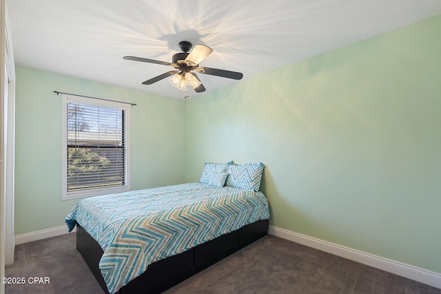 bedroom featuring ceiling fan and dark colored carpet