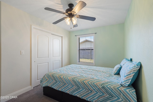 carpeted bedroom with ceiling fan and a closet