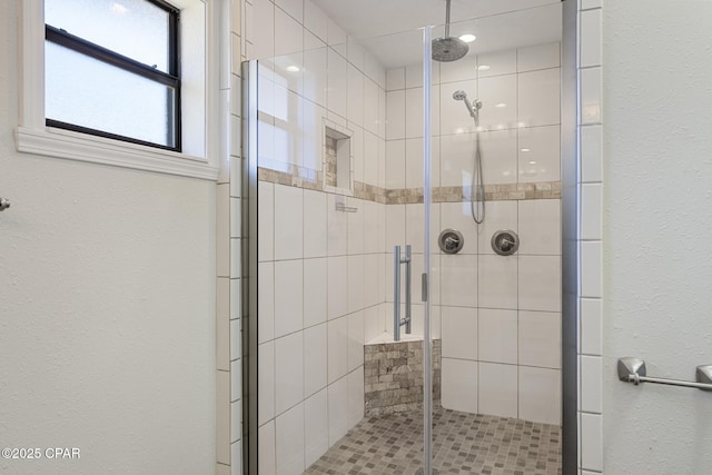 bathroom with a shower with door