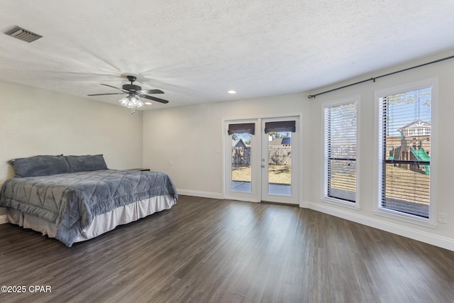 bedroom featuring ceiling fan, access to outside, dark hardwood / wood-style flooring, and a textured ceiling