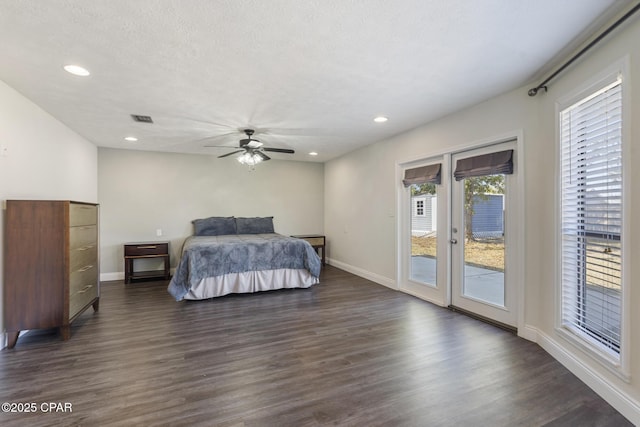 bedroom with access to outside, ceiling fan, dark wood-type flooring, and multiple windows