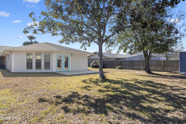 back of property featuring a lawn, french doors, and a patio area