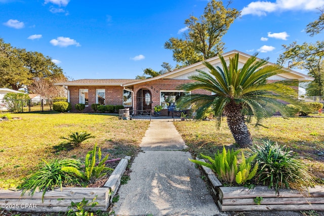 ranch-style home with a front lawn