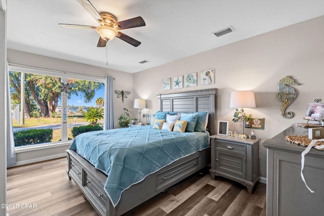 bedroom with ceiling fan and hardwood / wood-style flooring