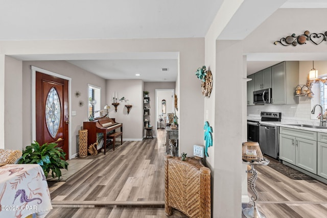 entrance foyer with light wood-type flooring and sink