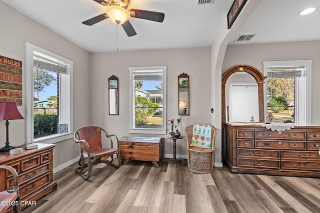 living area featuring ceiling fan and hardwood / wood-style floors