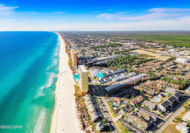 bird's eye view featuring a water view and a beach view