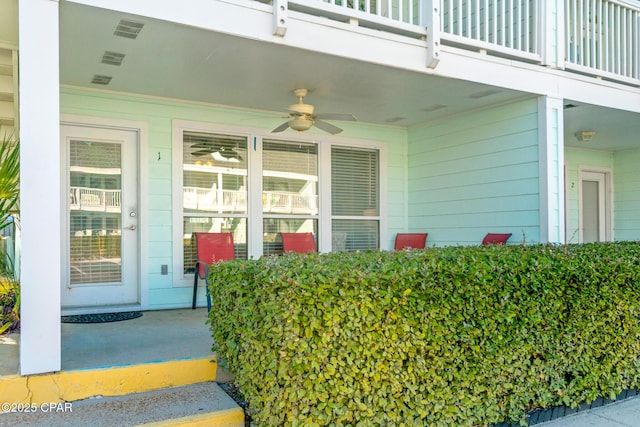 doorway to property featuring ceiling fan and a balcony