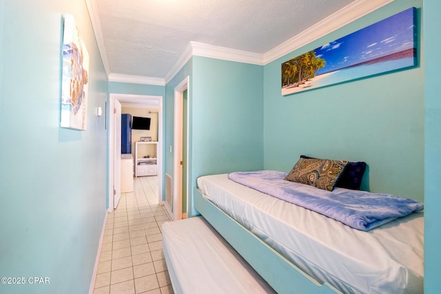 bedroom with light tile patterned flooring and ornamental molding