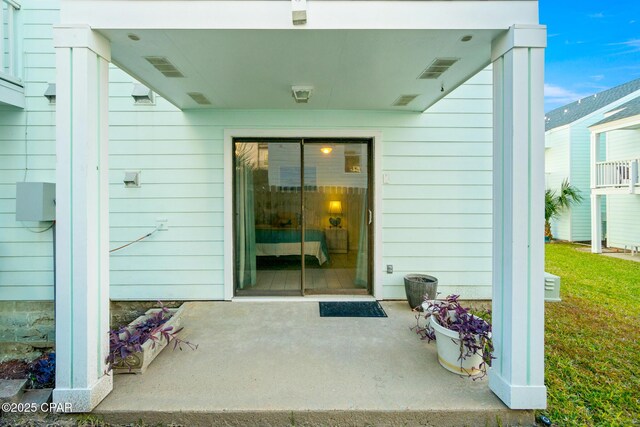 property entrance featuring a patio