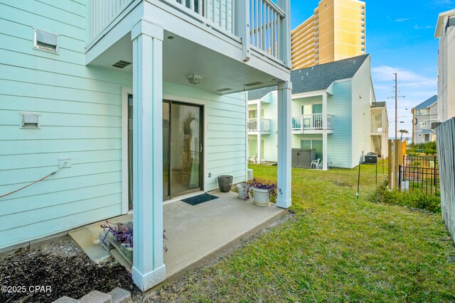 exterior space featuring a patio area, a lawn, and a balcony