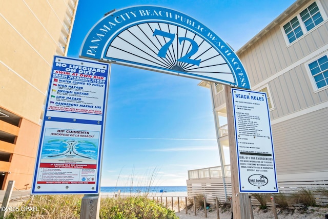 exterior details with a water view and a view of the beach