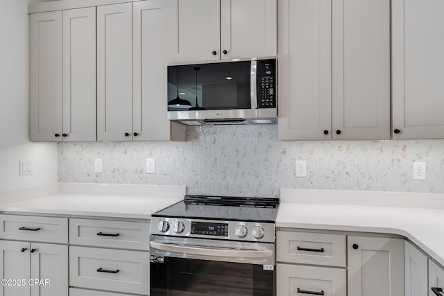 kitchen with white cabinets and appliances with stainless steel finishes