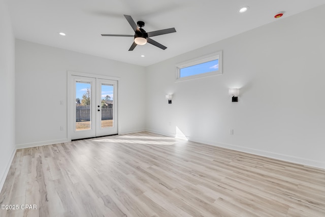 unfurnished room with light hardwood / wood-style floors, ceiling fan, and french doors