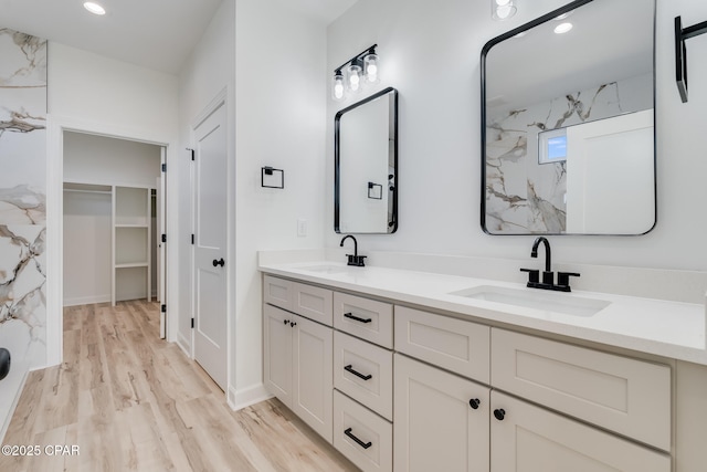 bathroom with a shower, wood-type flooring, and vanity