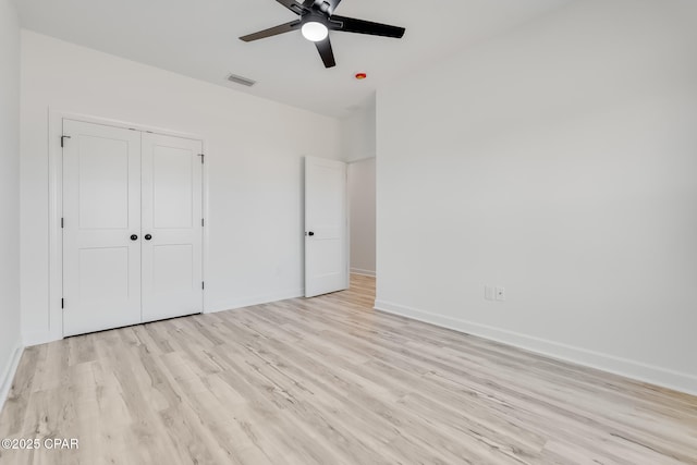 unfurnished bedroom featuring a closet, ceiling fan, and light hardwood / wood-style flooring