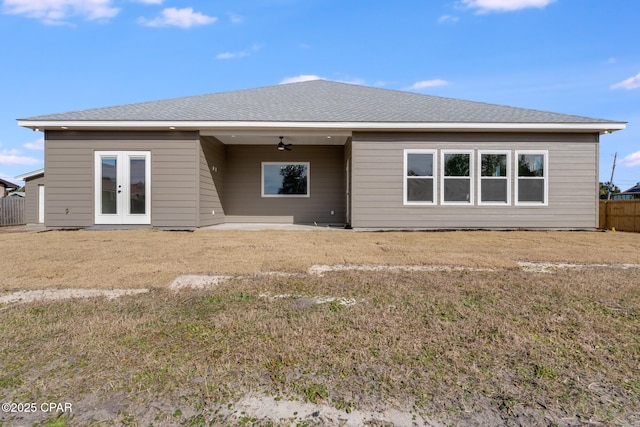 back of property with a lawn, a patio, ceiling fan, and french doors