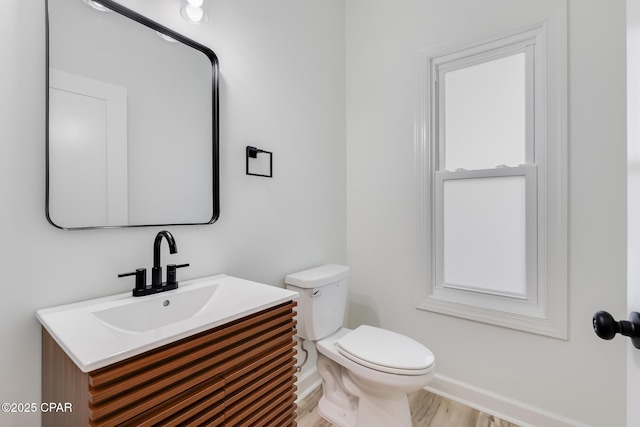 bathroom featuring hardwood / wood-style floors, toilet, and vanity