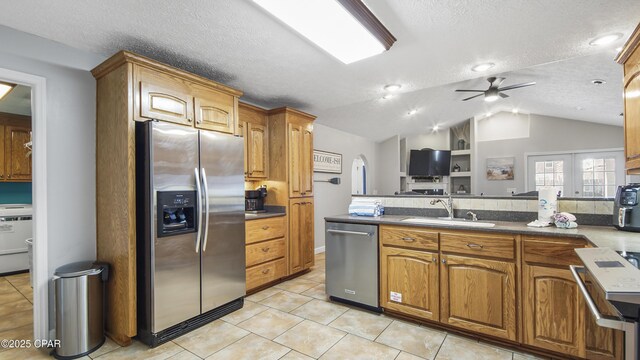 kitchen with kitchen peninsula, appliances with stainless steel finishes, backsplash, a kitchen breakfast bar, and light tile patterned flooring