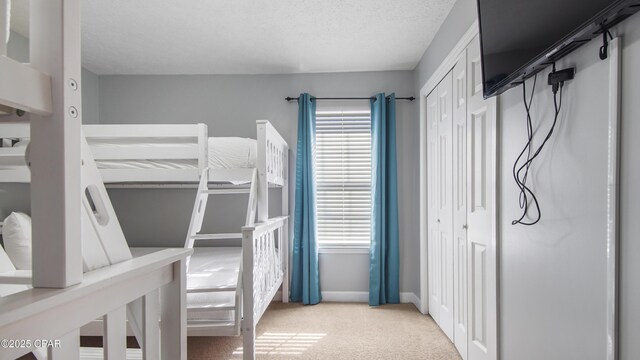 carpeted bedroom featuring a textured ceiling