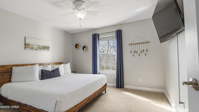 bedroom featuring a textured ceiling, ceiling fan, and carpet floors