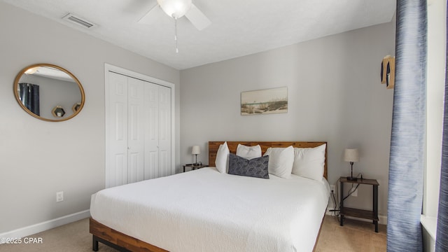 carpeted bedroom featuring ceiling fan and a closet