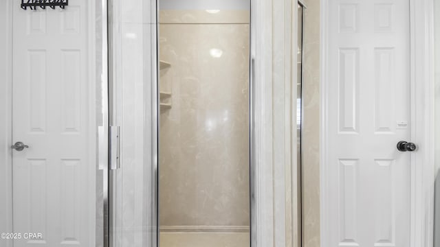 bathroom featuring a shower with shower door