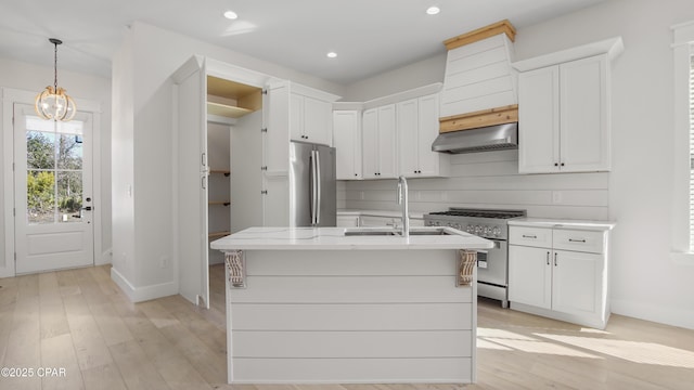 3511 Cottage Cove Ln, Panama City, FL 32408 - kitchen with appliances with stainless steel finishes, under cabinet range hood, light wood-type flooring, white cabinets, and recessed lighting