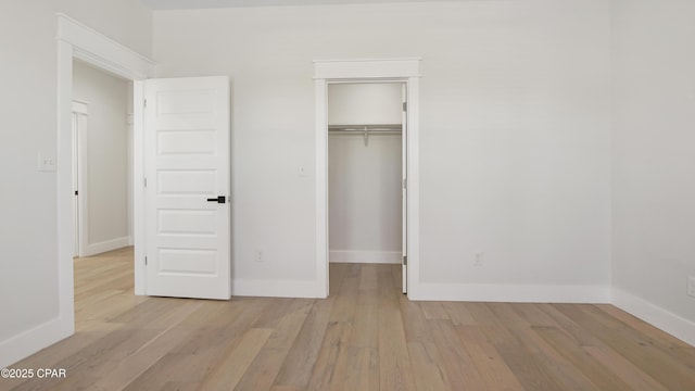 unfurnished bedroom featuring a closet and light hardwood / wood-style flooring