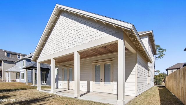 rear view of property with a lawn and a patio area