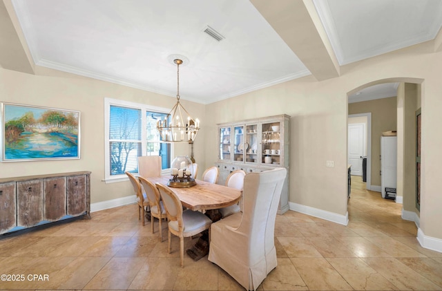 dining space featuring arched walkways, crown molding, a notable chandelier, visible vents, and baseboards