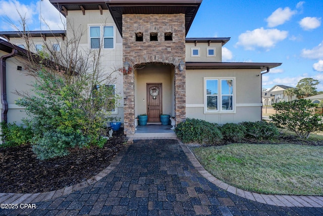 view of front facade with stone siding and stucco siding