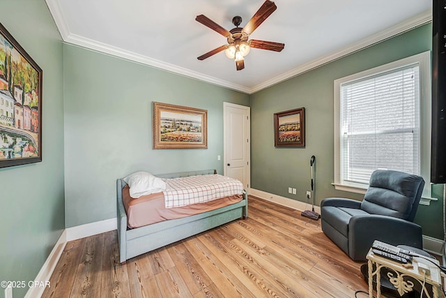 bedroom with baseboards, ornamental molding, a ceiling fan, and light wood-style floors