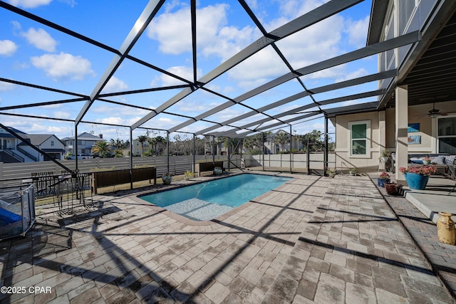 pool with glass enclosure and a patio area