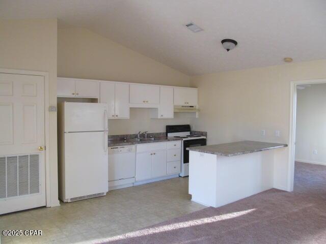 kitchen featuring white appliances, a center island, white cabinetry, sink, and high vaulted ceiling