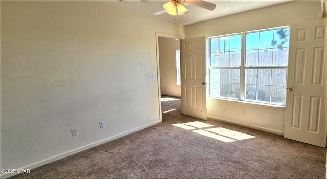 unfurnished bedroom with carpet floors, multiple windows, and baseboards