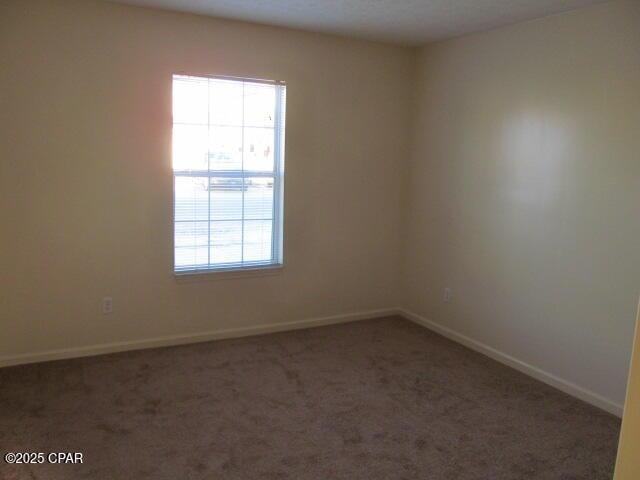 empty room featuring dark colored carpet