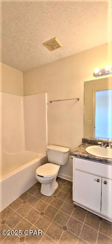 bathroom featuring visible vents, toilet, tub / shower combination, vanity, and tile patterned floors