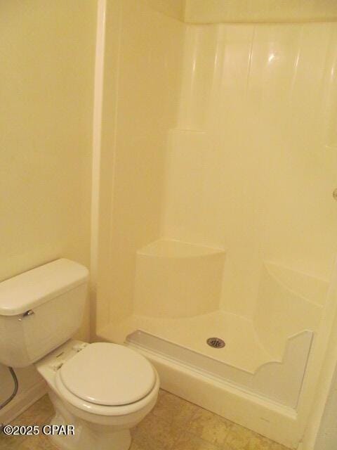 full bath with toilet and a shower stall