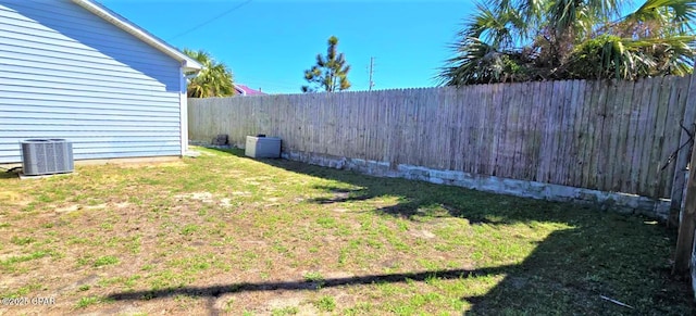 view of yard with a fenced backyard and cooling unit