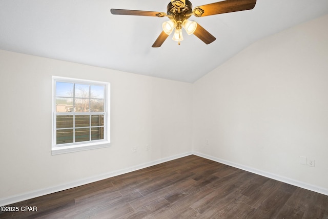 empty room featuring ceiling fan, vaulted ceiling, and dark hardwood / wood-style flooring