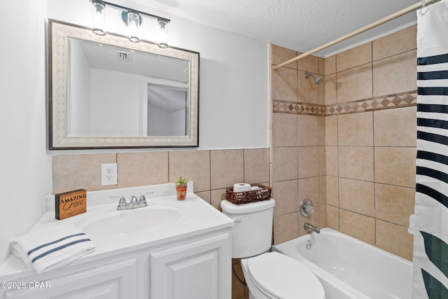 full bathroom with a textured ceiling, vanity, backsplash, toilet, and tile walls