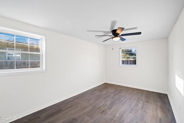 empty room with ceiling fan and dark hardwood / wood-style floors