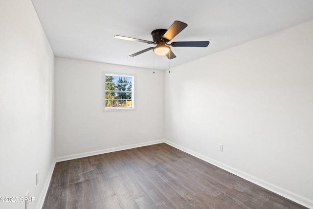 spare room featuring ceiling fan and dark hardwood / wood-style floors