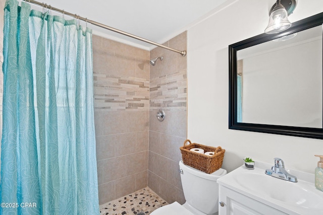 bathroom with toilet, vanity, and curtained shower