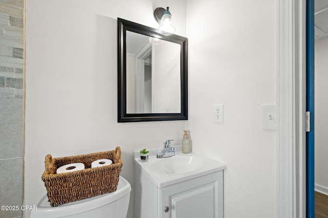 bathroom featuring toilet and vanity